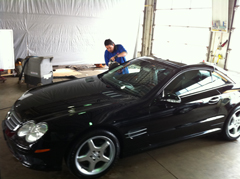 man working on window tinting in shop